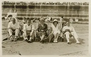 Relatives Prints: A lovely group photo of five friends (or relatives) sitting on deckchairs on the beach