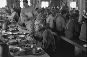 Lumberjacks eating dinner at camp near Effie, Minnesota