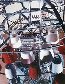 Employee Prints: A machine collects coloured yarn onto rolls