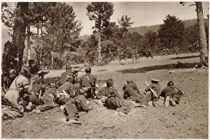 A machine-gun section of the Republican army (foreground) covering the advance of an infantry unit, during fighting in the Guadarrama Hills in the early stages of the Spanish Civil War. Date: 1936