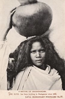 Madagascan Collection: Madagascar - Girl carrying a large round jar