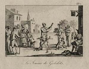 Magician performing the cup and balls trick to an assembled