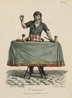Magician performing trick on table with cup and balls