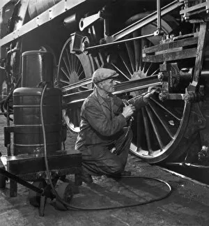 Trains Collection: Maintenance worker greasing pivots and slides