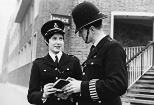 Male and female police officers in a London street