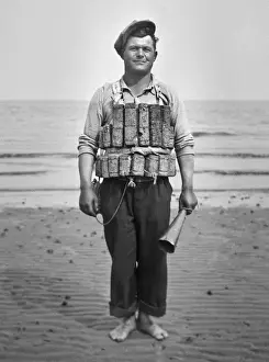 Man on beach in cork lifebelt