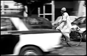 Man on bike in Cairo traffic, Egypt