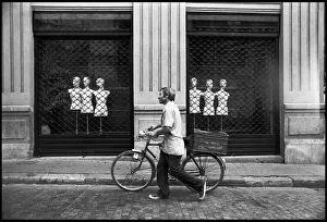 Man with bike shop front, Valencia, Spain