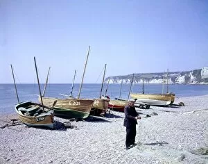 Nets Gallery: Man with boats and fishing nets at Seaton, Devon