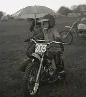 Competing Prints: Man and boy with junior sized motorcycle