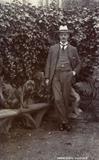 Foliage Gallery: Man with a bulldog in a garden