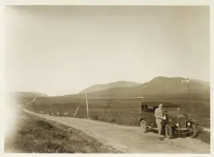 Man and car in the Scottish Highlands