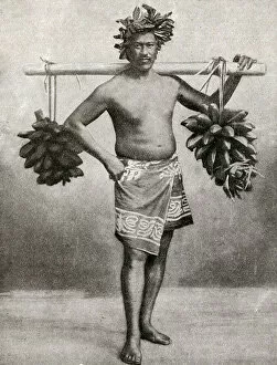Images Dated 4th September 2018: Man carrying fruit on a pole, Tahiti, French Polynesia