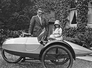 Man and two children with motorbike and sidecar
