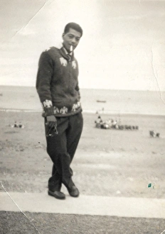 Man with cigarette and knitted cardigan standing on the beac Man with cigarette and knitted cardigan standing on the beac