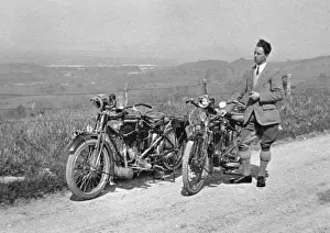 Man on country lane with two motorbikes