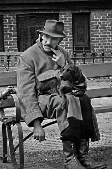 Man and dog resting on a bench
