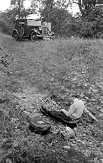 Man in a field with parked car