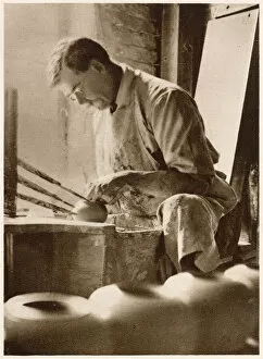A man forming articles upon the potters wheel: a thrower. Date: 1913