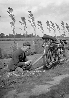 Man with motorbike in a field