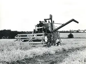 Man operating a combine harvester, Cornwall
