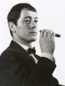 Poses Collection: A man poses in a dinner jacket smoking a cigar. Date: late 1960s
