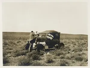 Man pouring water into car radiator, Middle East