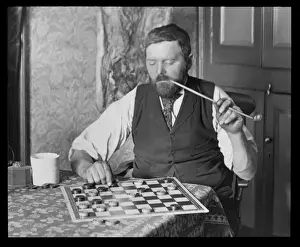 Churchwarden Prints: Man puzzling over a game of draughts