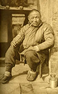 Relax Gallery: Man relaxing and smoking his pipe, China, East Asia