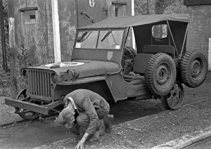 Mechanic Prints: Man repairing a jeep