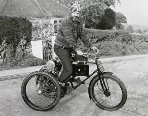 Man riding an 1899 Marot-Gardon vintage tricycle