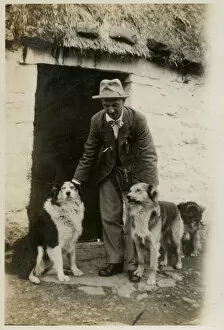 Man in Scotland with three collie dogs