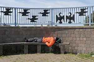 Images Dated 4th September 2019: A man sleeps on a bench on Morecambe promenade