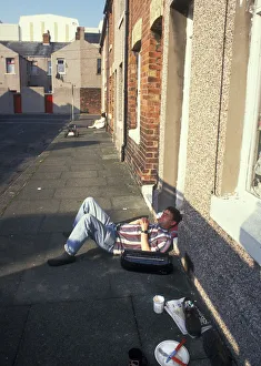 Relax Gallery: Man snoozing outside his house in Stewart Street, Barrow in