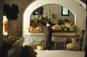 Tunisian Collection: Man stands at a fruit and vegetable stall in Djerba, Tunisia