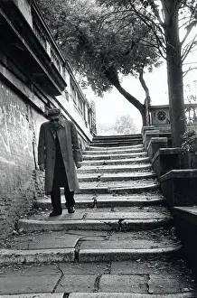 Paved Prints: Man on steps in Rome, Italy