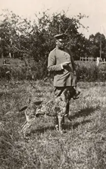Mottled Prints: Man in uniform with a dog in a field, Germany