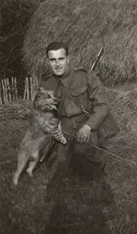 Man in uniform with a terrier dog at a farm