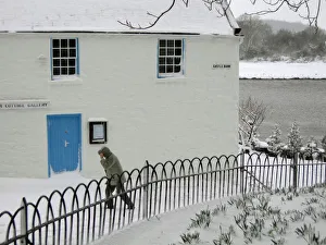 Cold Gallery: Man walks past the Harbour Cottage Gallery in Kirkcudbright