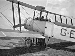 Sunglasses Prints: Man and woman in a biplane on an airfield
