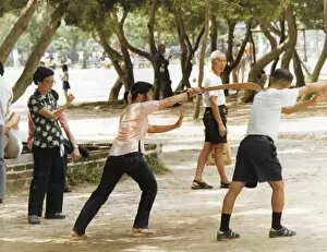 Man and woman shadow boxing in the park in Hong Kong