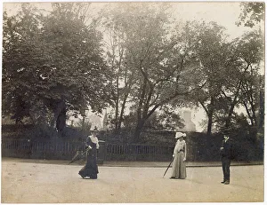 Parasols Prints: Man and two women in the middle of a road
