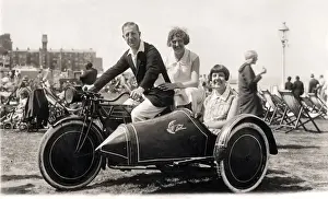 Man & two women on veteran motorcycle combination