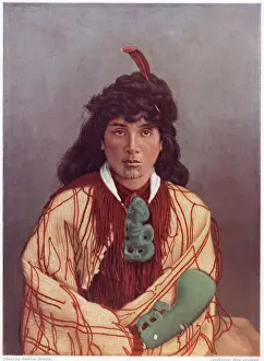 Maori woman in traditional dress, with a greenstone ornament and a club Date