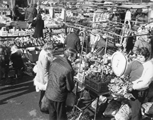 Weighing Prints: A market trader weighing vegetables on a large set of weighing scales at Lichfield Market
