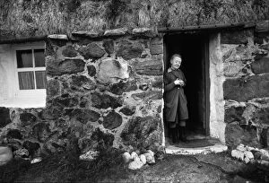 Macdonald Collection: Mary MacDonald outside her crofters cottage, Outer Hebrides