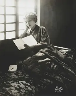 Pickford Prints: Mary Pickford, wearing a kimono, reading a letter