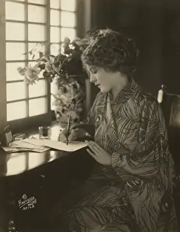 Pickford Prints: Mary Pickford, wearing a kimono, writing at a desk