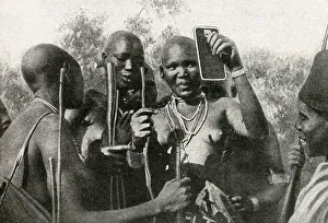 Images Dated 7th August 2018: Masai women of East Africa looking in a mirror