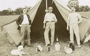 Three men camping with a dog